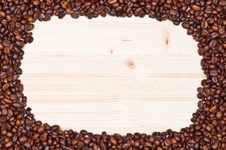 Coffee beans isolated on natural woodの写真素材