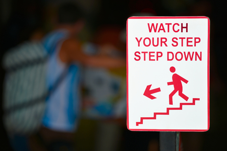 Watch your step sign - step downの写真素材