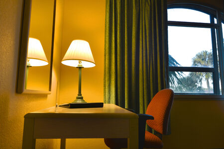 Lamp and desk in a hotel roomの写真素材