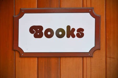 Books shop sign hanged on a wooden wall の写真素材