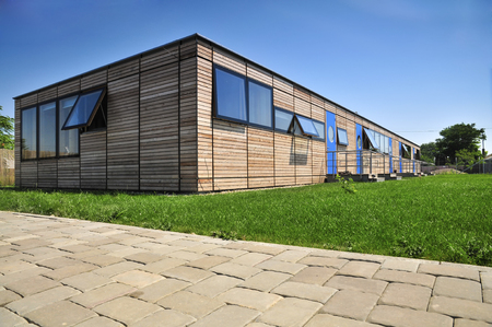 Facade of modern architecture - walls and shutters made of wood Ecological and unique house Facade of modern architecture - walls and shutters made of wood Ecological and unique house