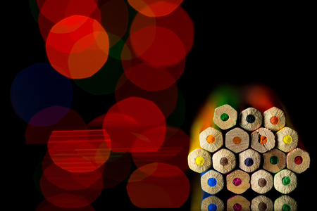 A lot of pencils in black background with colorful bokehの写真素材
