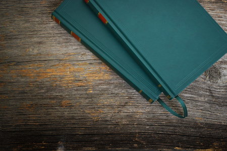 Green book on a textured wood backgroundの写真素材