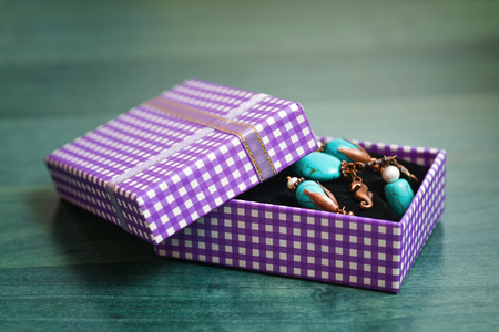 Purple gift box with green wooden 