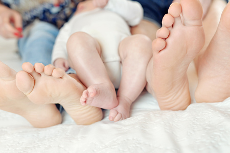 Feet mother, father, and child in a loving family stanceの写真素材