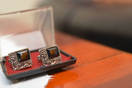 Silver Cufflinks placed in a plastic black boxの写真素材