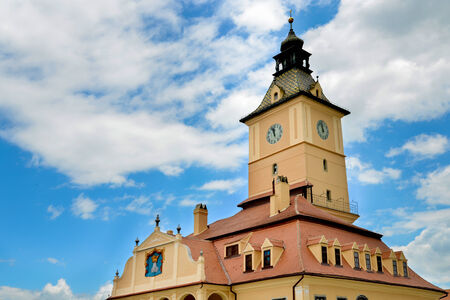 The tower of a church in Romania with a beautiful and full of cloudsの写真素材