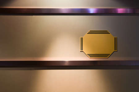 Simple yellow sign hanging on wallの写真素材