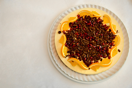 Lemon tart with pomegranate and chocolate chipsの写真素材