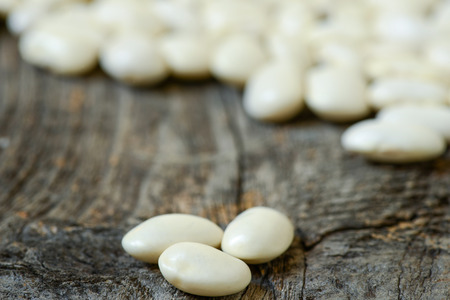 Beans isolated on a wooden textureの写真素材