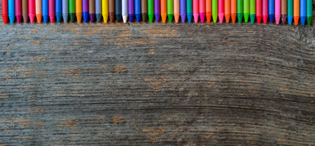 Coloring pencils aligned on wooden backgroundの写真素材