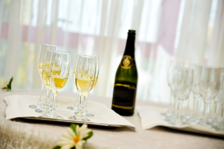 Champagne bottle with six filled glassesの写真素材