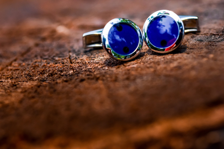 Cufflinks blue shirt sitting on a wooden surfaceの写真素材