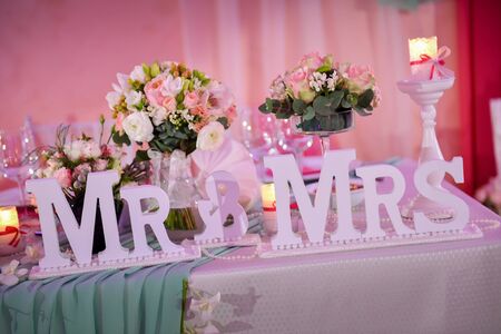 Beautiful wedding table with Mr. & Mrs. in natural lightの写真素材