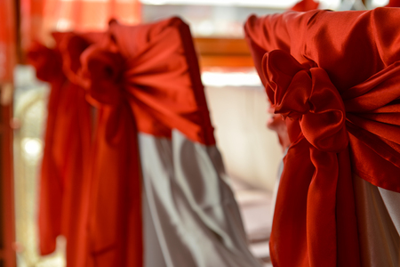 Red bow tied on the back of chairの写真素材