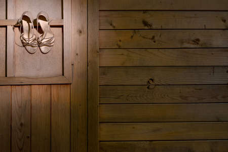 Bride shoes hanged on wood wallの写真素材