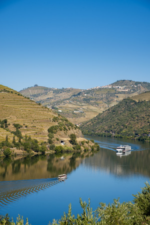 Peso da Regua, Portugal - October 05, 2018 : Boat carrying tourists on the Douro River, Vila Real, Portugalの写真素材