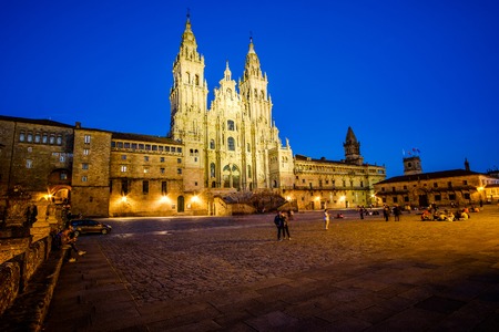Santiago de Compostela , Spain - May 12, 2019: Tourists and pilgrims roam the streets where magnificent buildings are situated in the historic Spanish city, Santiago de Compostela, Spain.のeditorial素材