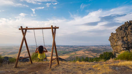 Mogadouro, Portugal - August 26, 2021 : Woman swinging on top of the mountain, Braganca District, Portugalのeditorial素材