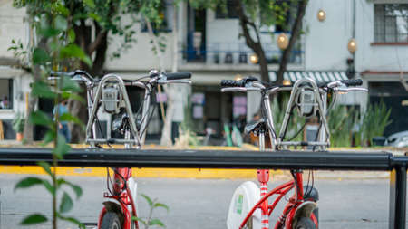 Public Bicycles Parked on the Street with a Blurry Building as Background