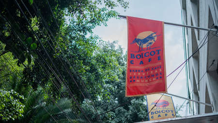 Banner Hanging Outside a Cafe With Trees in the Background in Mexico Cityの写真素材
