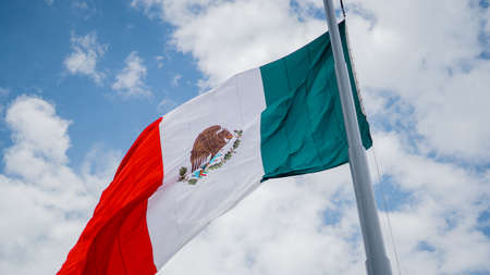 Mexican Flag Waving in the Wind and Blue Cloudy Skyの写真素材