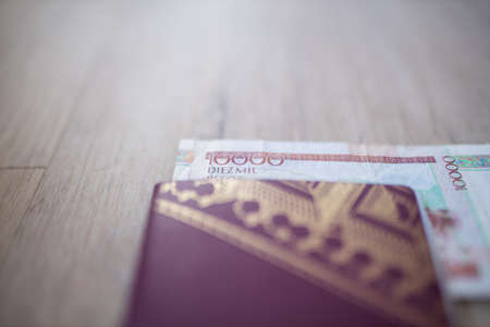 Ten Thousand Colombian Pesos Bill Partially inside a Swedish Passport