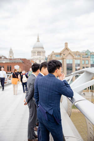 Portrait View of Young Men in Business Suits on the Millenium Bridgeのeditorial素材