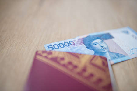 Corner of a Fifty Thousand Rupees Bill Partially Inside a Swedish Passportの写真素材
