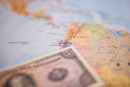 Five sucres bill below Ecuador on a colorful and blurry map of South Americaの写真素材