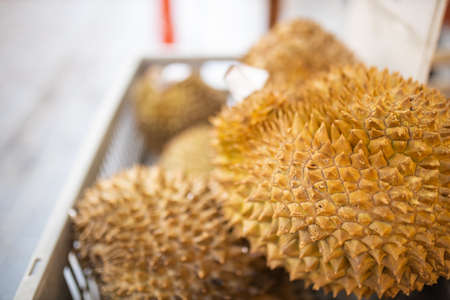 Spikey and yellow fruits named durian in a basket on the street