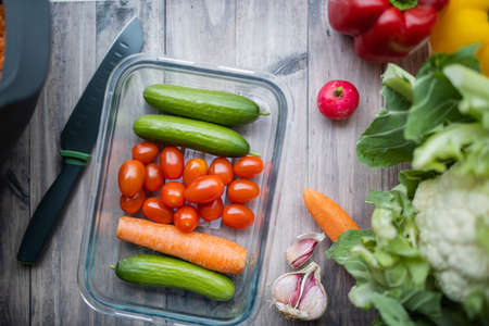 Carrots, zucchini, tomatoes, and more vegetables on a wooden table