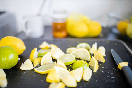 Lemons and limes slices on a black trayの写真素材