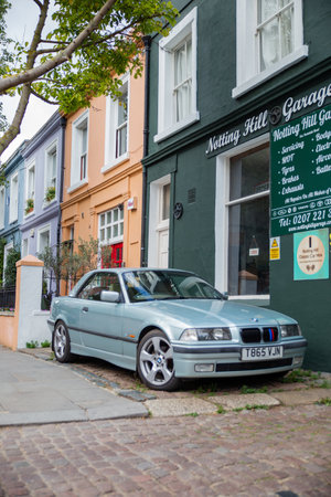 Luxurious German car parked outside a British car workshopのeditorial素材