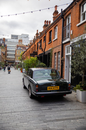 Classic luxury car parked outside a brick houseのeditorial素材