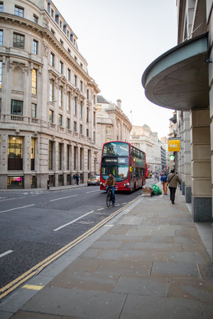 Buildings with classic architecture in British street with a bus passing byのeditorial素材