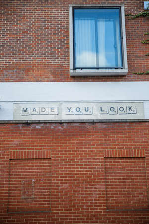 Made you look message under a window on a brick wallの写真素材