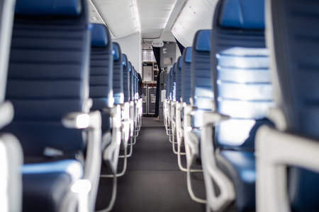 Empty dark blue passenger airplane seats in the cabin.の写真素材