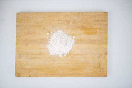 Small pile of flour on a cutting board