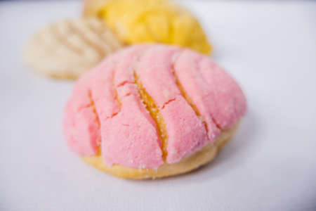 Colorful Mexican sweet bread on a white table