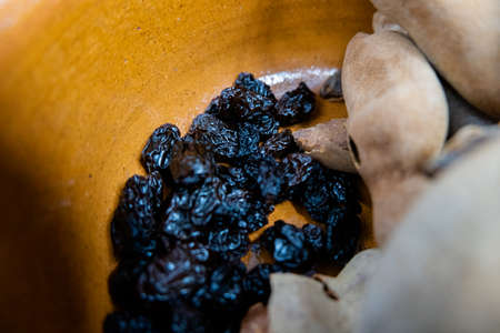 Fresh tamarind and raisins inside a clay bowlの写真素材