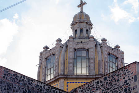 Dome from old Mexican Church under cloudy sky