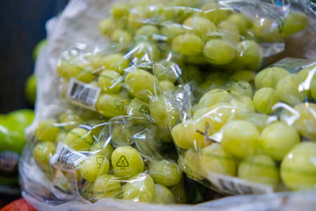 Close-up of plastic bags of fresh green grapesの写真素材
