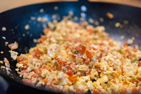 Delicious Mexican-style scrambled eggs in a frying panの写真素材