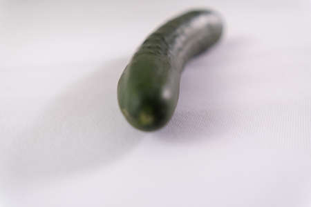 Fresh whole cucumber isolated on a white surfaceの写真素材