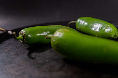 Green chili peppers on a traditional Mexican comalの写真素材
