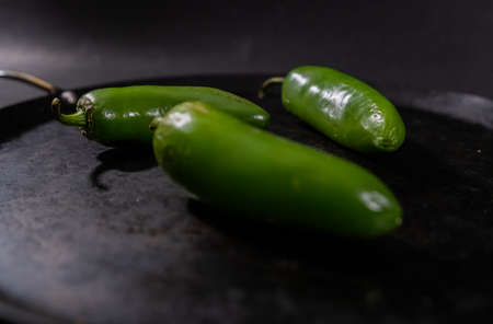 Green chili peppers on a traditional Mexican comalの写真素材