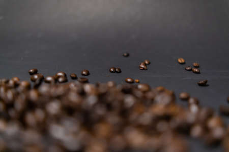 Pile of roasted coffee beans with dark gray backgroundの写真素材
