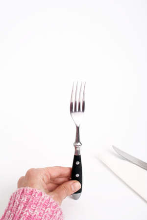 hand and fork close-up, isolatedの写真素材
