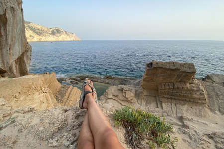 Legs of a woman on Atlantis beach on Ibiza islandの写真素材